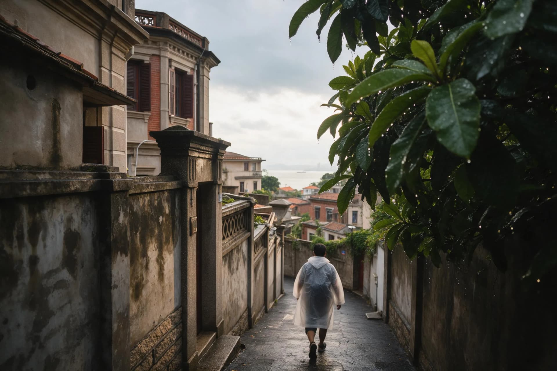 Rainy afternoon lane on Gulangyu, Xiamen, with historic villas and the sea beyond