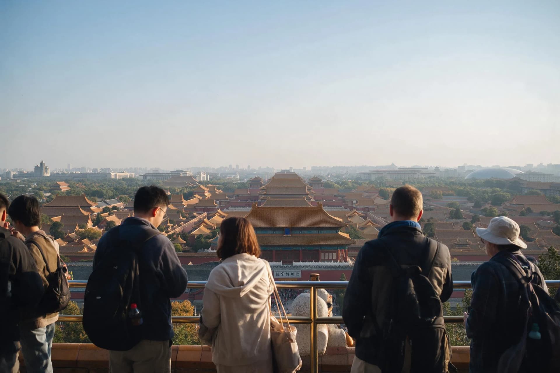 Golden late-afternoon light over the Forbidden City rooftops from Jingshan Park in Beijing, China, seen from Wanchun Pavilion